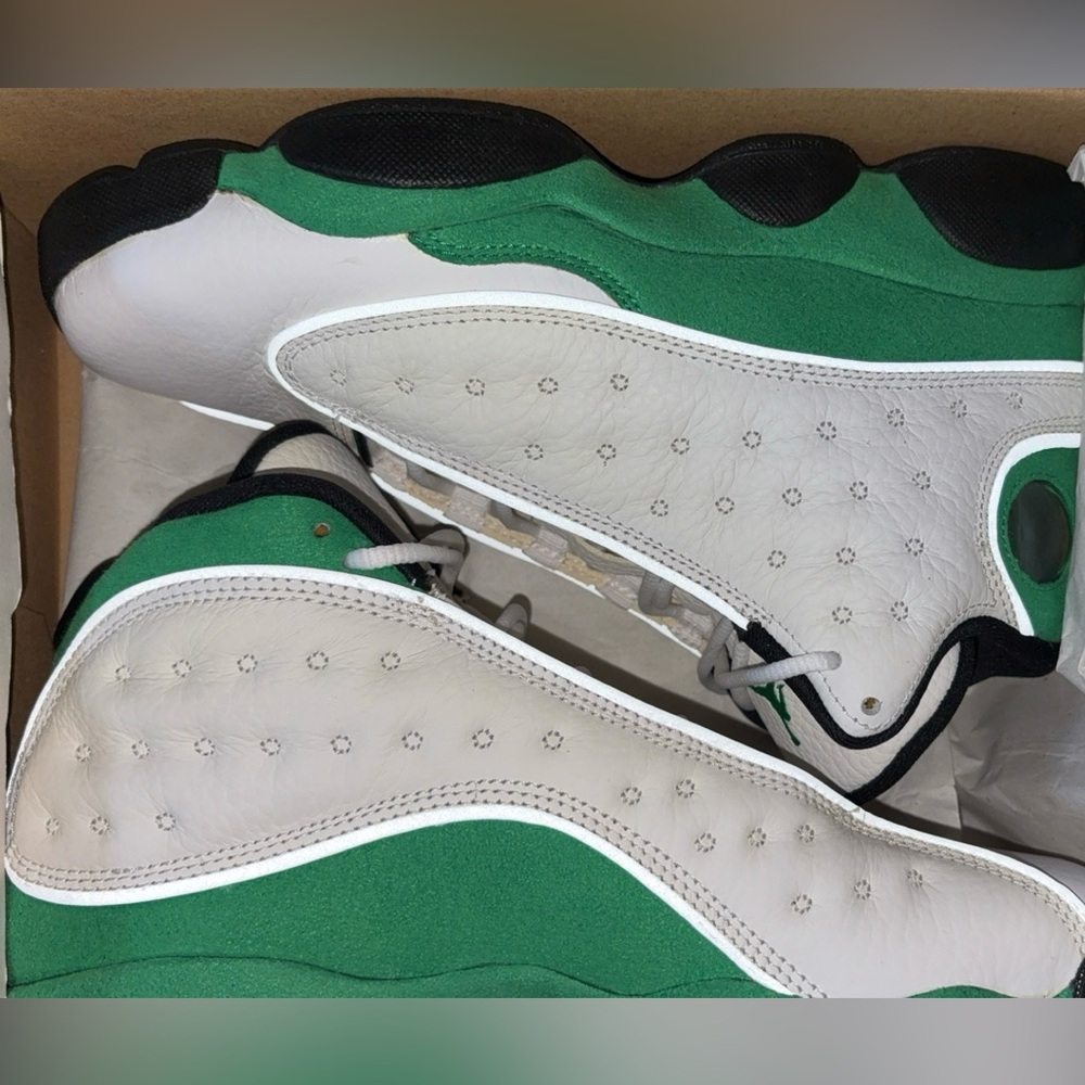 Air Jordan 13 Retro’s white, black and lucky green.